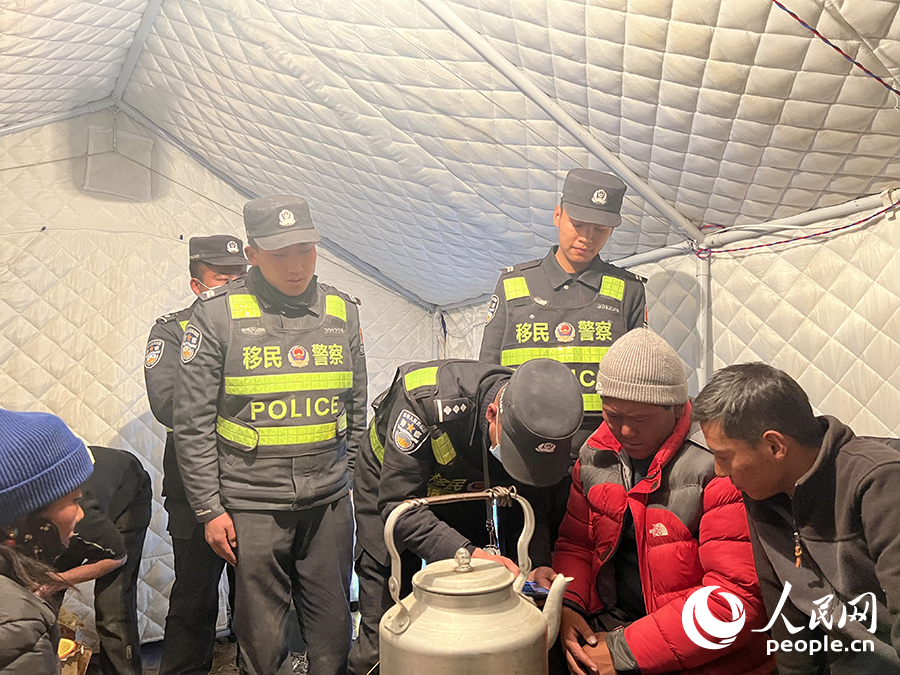 00后洛桑多吉（左）和馬樂聘（右）開展防火宣傳。人民日?qǐng)?bào)記者 瓊達(dá)卓嘎攝